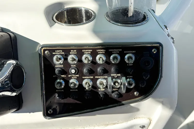 Slide: The Image of Control panel of a 2017 NauticStar 2602 Legacy boat with various switches. - 14