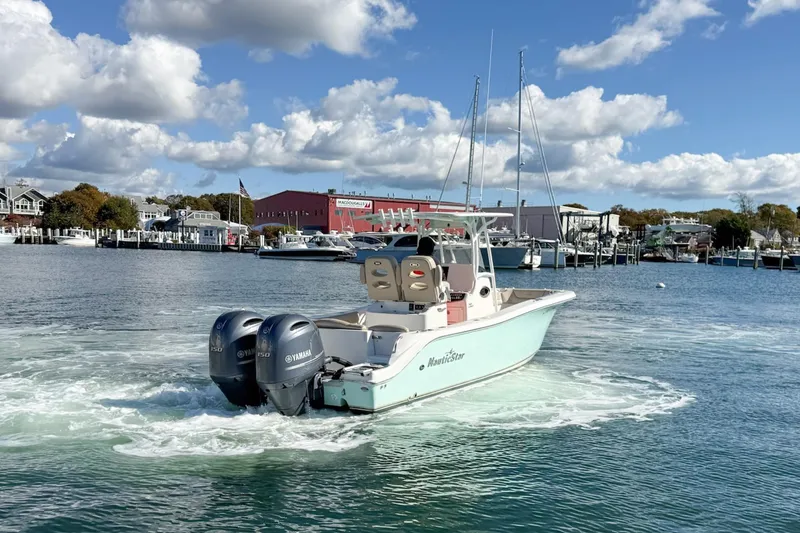 Slide: The Image of 2017 NauticStar 2602 Legacy boat with twin Yamaha engines on a sunny day. - 3