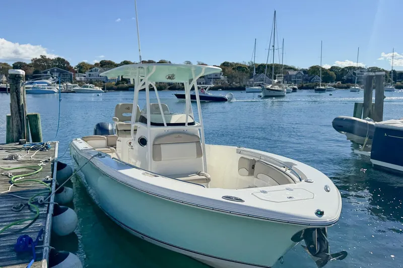 Slide: The Image of 2017 NauticStar 2602 Legacy boat docked in a scenic marina. - 4