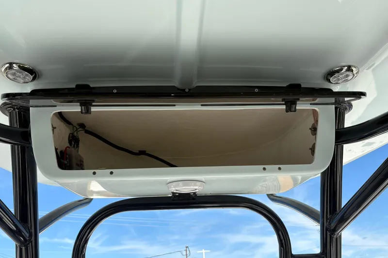 Slide: The Image of 2026 Key West 230 Bay Reef boat storage compartment with open hatch and blue sky background. - 16