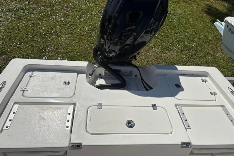 Slide: The Image of 2026 Key West 230 Bay Reef boat with outboard motor on grassy area. - 4