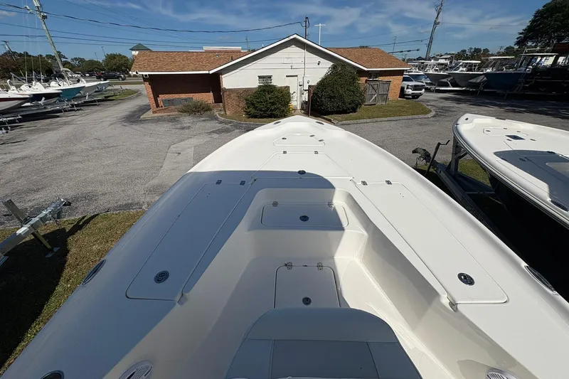 Slide: The Image of 2026 Key West 230 Bay Reef boat on display at a dealership. - 9