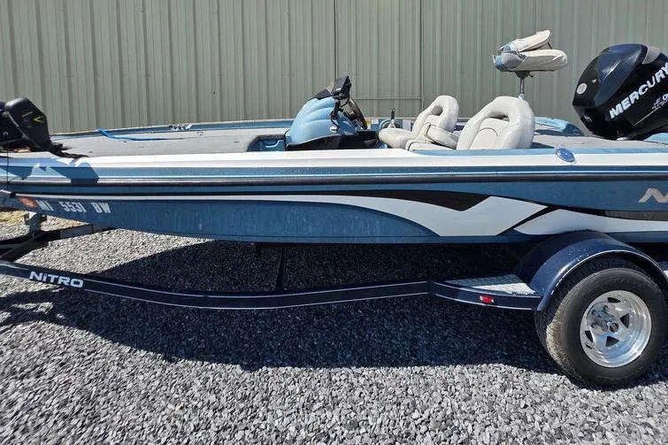 Slide: The Image of 2008 Nitro 482 DC boat with Mercury engine on gravel surface. - 1