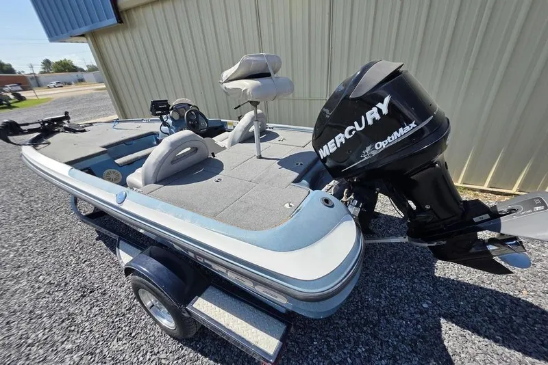 Slide: The Image of 2008 Nitro 482 DC boat with Mercury OptiMax engine, parked on gravel. - 11