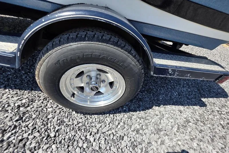 Slide: The Image of Trailer wheel of a 2008 Nitro 482 DC boat on gravel surface. - 14