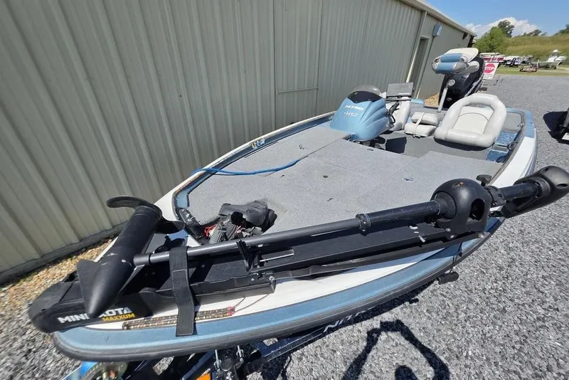 Slide: The Image of 2008 Nitro 482 DC boat with Minn Kota trolling motor, parked on gravel. - 2