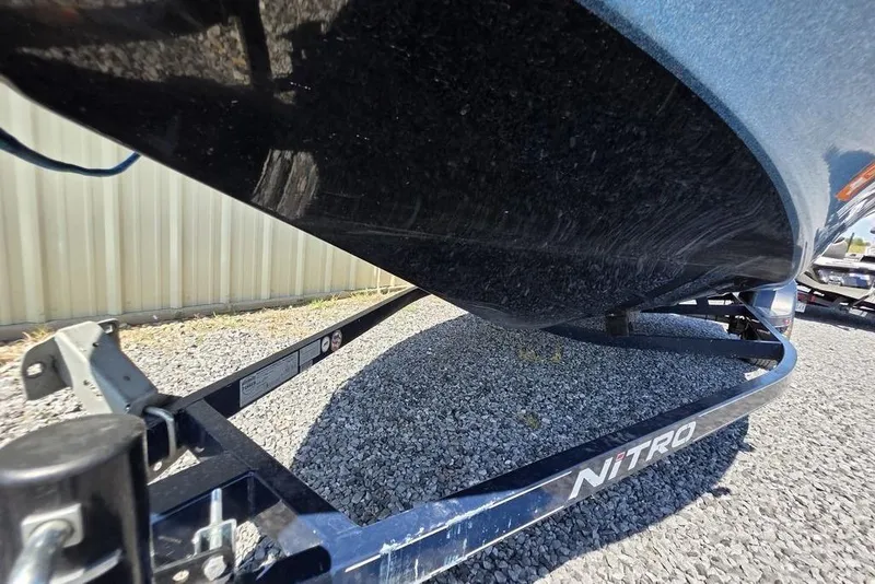 Slide: The Image of 2008 Nitro 482 DC boat on trailer, gravel surface, side view. - 4