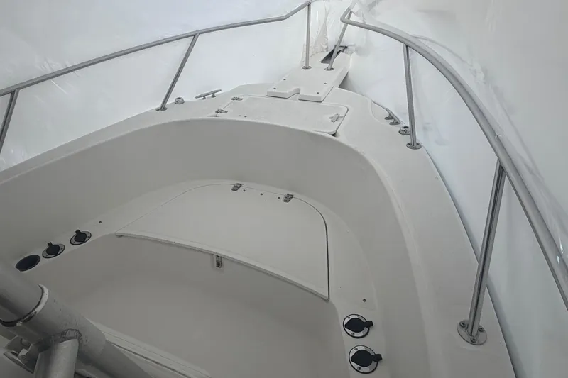 Slide: The Image of 1999 Boston Whaler 210 Outrage boat interior with white seating and stainless steel railings. - 3