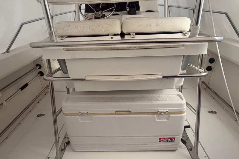 Slide: The Image of 1999 Boston Whaler 210 Outrage interior with seating and Igloo cooler. - 6