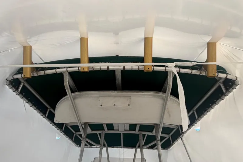Slide: The Image of 1999 Boston Whaler 210 Outrage boat canopy with rod holders, viewed from below. - 7