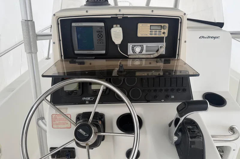 Slide: The Image of 1999 Boston Whaler 210 Outrage boat dashboard with steering wheel and navigation equipment. - 8