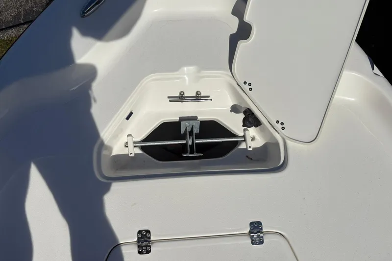 Slide: The Image of 2026 Key West 230 Bay Reef boat anchor compartment with open hatch. - 12