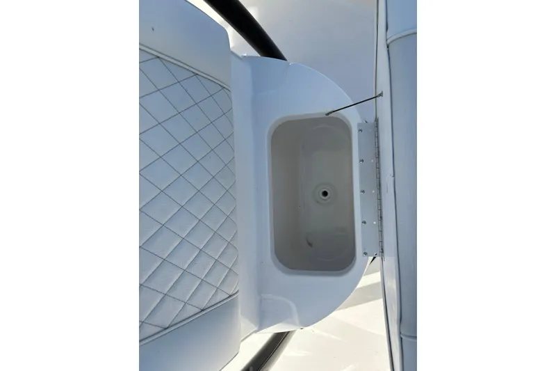 Slide: The Image of 2026 Key West 230 Bay Reef boat interior with storage compartment and quilted seating. - 14