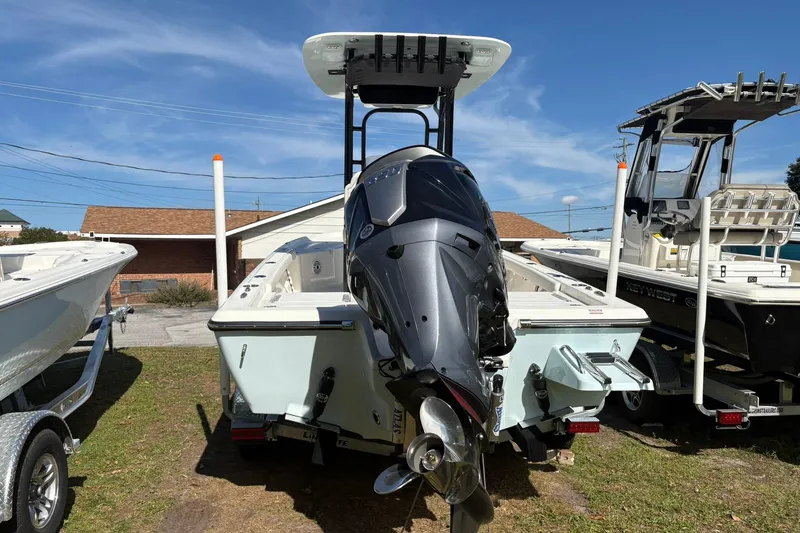 Slide: The Image of 2026 Key West 230 Bay Reef boat with powerful outboard motor, parked outdoors. - 2