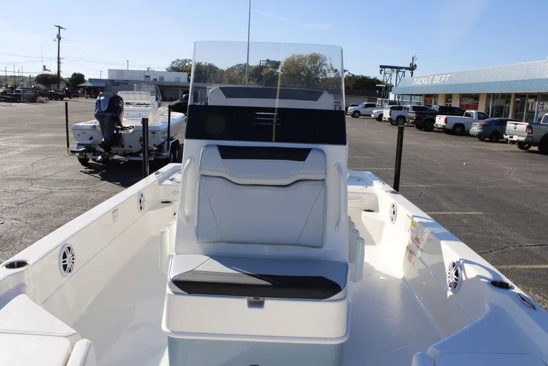 Slide: The Image of 2026 Skeeter SX221 boat with sleek design, parked outdoors in a dealership lot. - 10