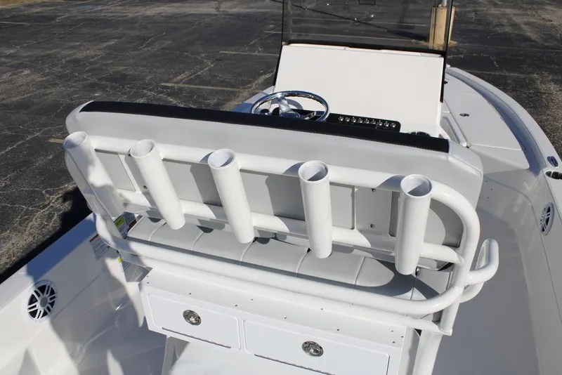 Slide: The Image of 2026 Skeeter SX221 boat interior with rod holders and steering console. - 12