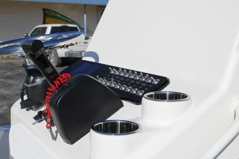 Slide: The Image of Control panel of 2026 Skeeter SX221 boat with switches and cup holders. - 13