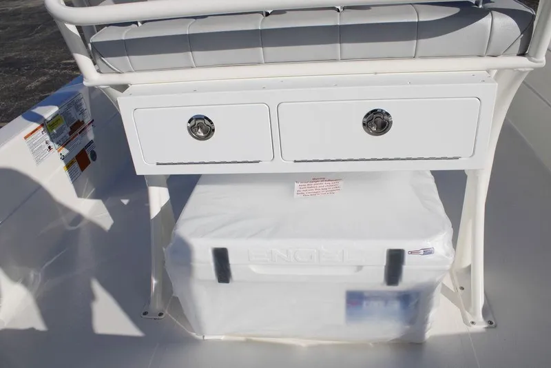 Slide: The Image of 2026 Skeeter SX221 boat storage area with drawers and cooler. - 15