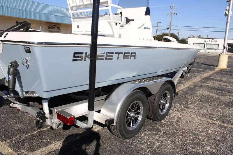 Slide: The Image of 2026 Skeeter SX221 boat on trailer, parked outdoors, showcasing sleek design. - 18