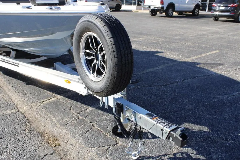 Slide: The Image of Trailer hitch and spare tire of 2026 Skeeter SX221 boat in parking lot. - 7