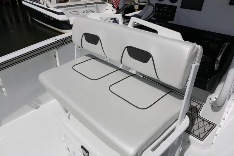 Slide: The Image of 2026 Wellcraft 202 Fisherman boat interior with cushioned seating and sleek design. - 22