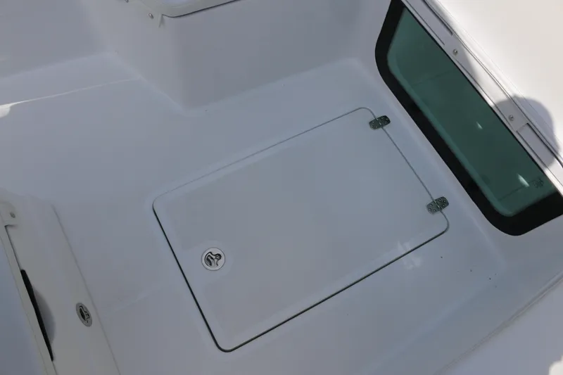 Slide: The Image of 2026 Wellcraft 202 Fisherman boat deck with storage compartment and window. - 8