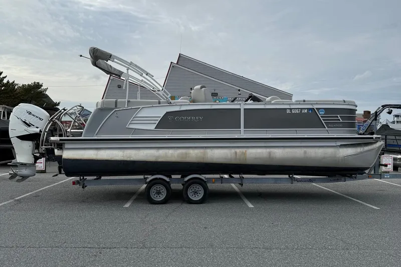 The Image of 2020 Godfrey AquaPatio 255 UL pontoon boat on trailer in parking lot. - 1
