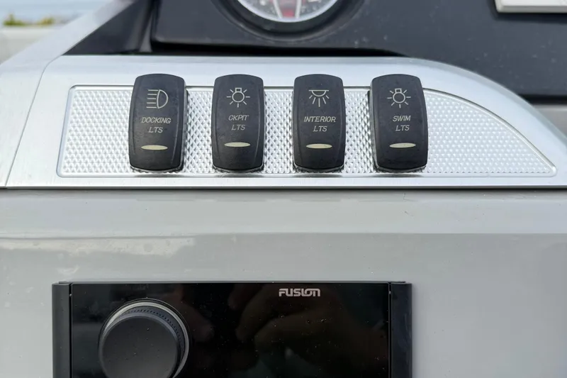 Slide: The Image of Control panel of a 2020 Godfrey AquaPatio 255 UL with light switches. - 17