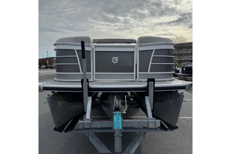 Slide: The Image of 2020 Godfrey AquaPatio 255 UL pontoon boat on trailer, parked outdoors. - 3