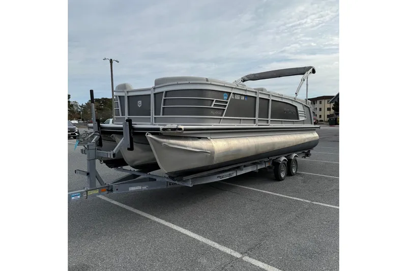 Slide: The Image of 2020 Godfrey AquaPatio 255 UL pontoon boat on trailer in parking lot. - 4