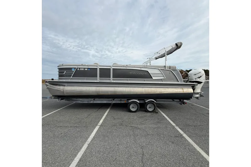 Slide: The Image of 2020 Godfrey AquaPatio 255 UL pontoon boat on trailer in parking lot. - 5