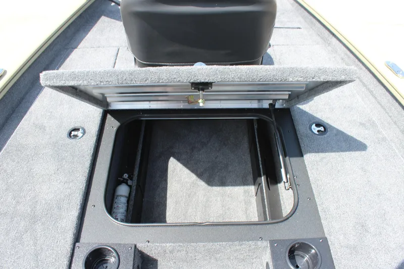 Slide: The Image of 2026 Tracker Pro Team 175 boat storage compartment with open hatch and fire extinguisher. - 13