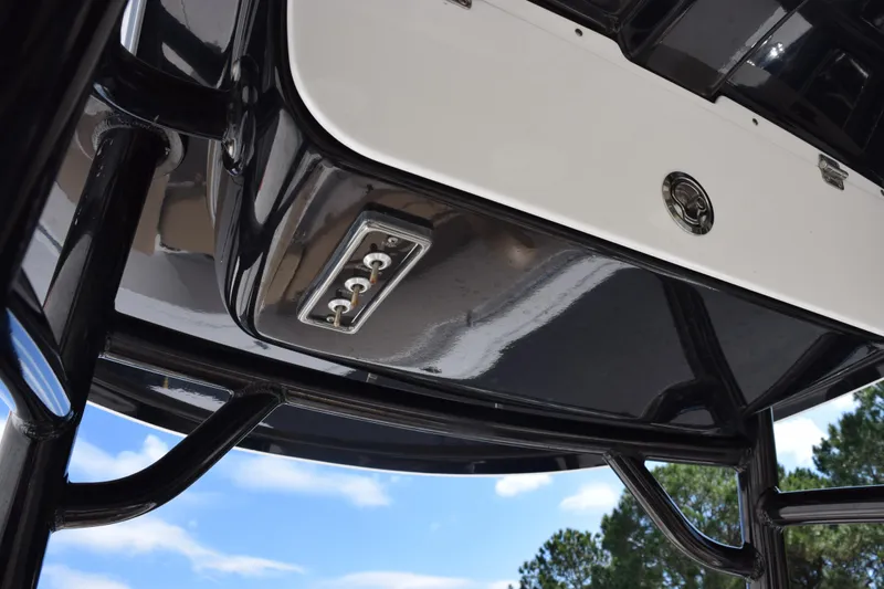 Slide: The Image of 2017 Sportsman Open 232 Center Console, underside view with control panel and blue sky. - 10