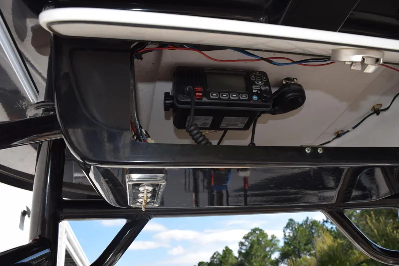 Slide: The Image of 2017 Sportsman Open 232 Center Console with mounted marine radio under T-top. - 11