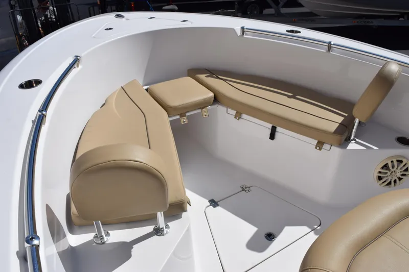 Slide: The Image of 2017 Sportsman Open 232 Center Console boat interior with beige seating and stainless steel railings. - 12