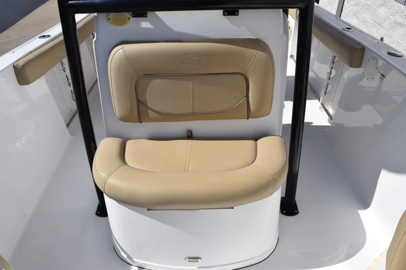 Slide: The Image of 2017 Sportsman Open 232 Center Console boat seating area with beige cushions. - 13