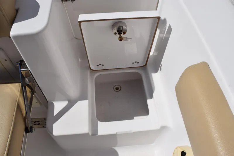 Slide: The Image of 2017 Sportsman Open 232 Center Console boat sink and storage compartment. - 20