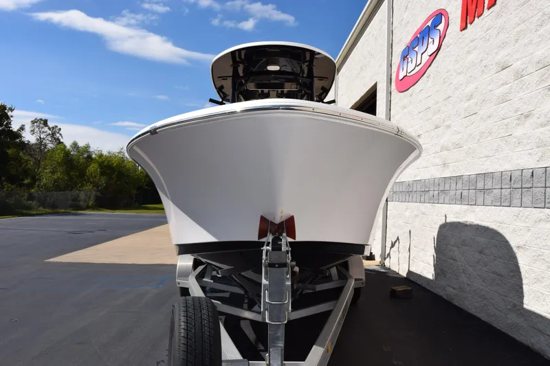 Slide: The Image of 2017 Sportsman Open 232 Center Console boat on trailer, parked outside a building. - 3