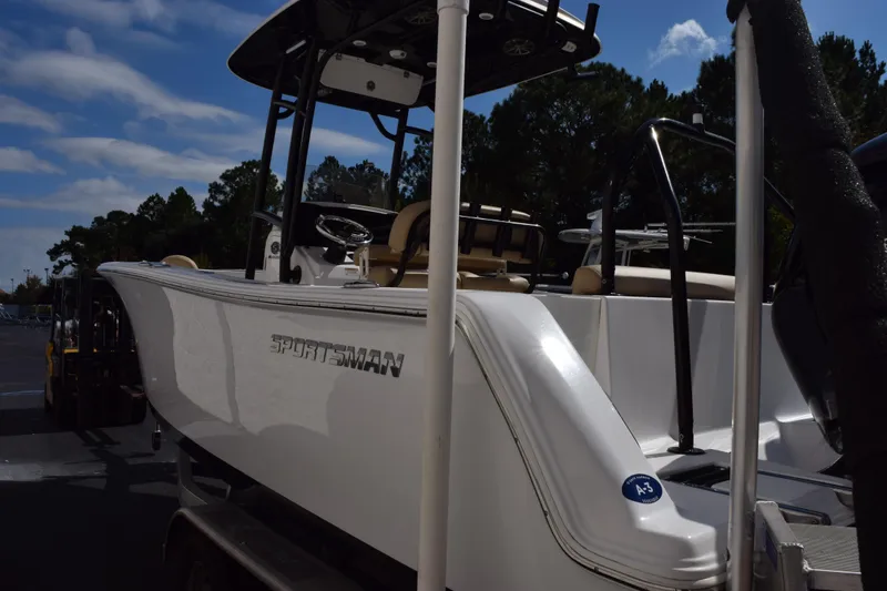 Slide: The Image of 2017 Sportsman Open 232 Center Console boat on trailer, parked outdoors. - 6