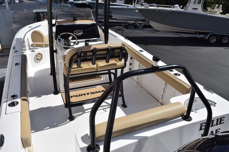 Slide: The Image of 2017 Sportsman Open 232 Center Console boat with beige seating and steering console. - 7