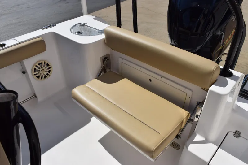 Slide: The Image of 2017 Sportsman Open 232 Center Console boat with tan seating and speaker detail. - 8
