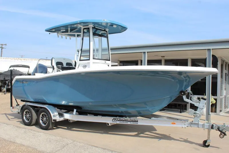 The Image of 2026 Tidewater 220 CC Adventure boat on trailer, blue hull, outdoor display. - 1