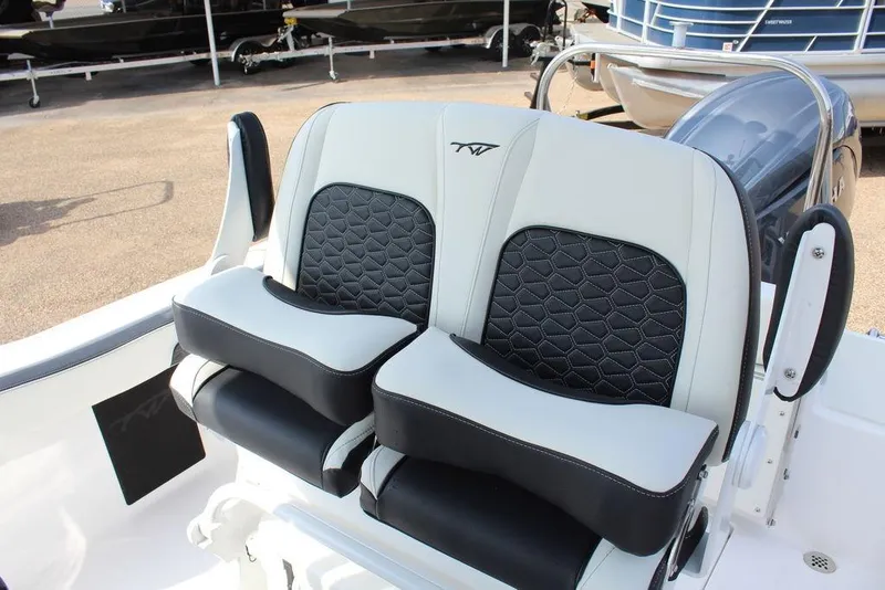 Slide: The Image of 2026 Tidewater 220 CC Adventure boat seats with black and white upholstery. - 11