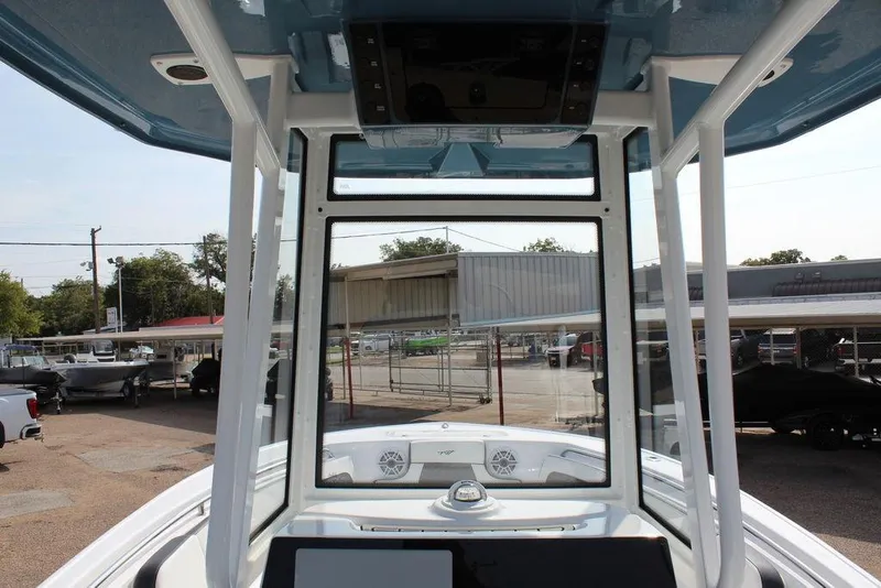 Slide: The Image of 2026 Tidewater 220 CC Adventure boat interior view with console and windshield. - 12