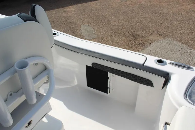 Slide: The Image of 2026 Tidewater 220 CC Adventure boat interior with rod holders and cushioned seating. - 16