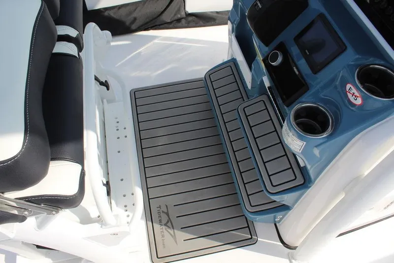 Slide: The Image of 2026 Tidewater 220 CC Adventure boat interior with sleek seating and modern console design. - 19