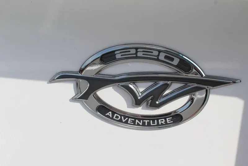 Slide: The Image of Chrome emblem of 2026 Tidewater 220 CC Adventure boat on white background. - 22