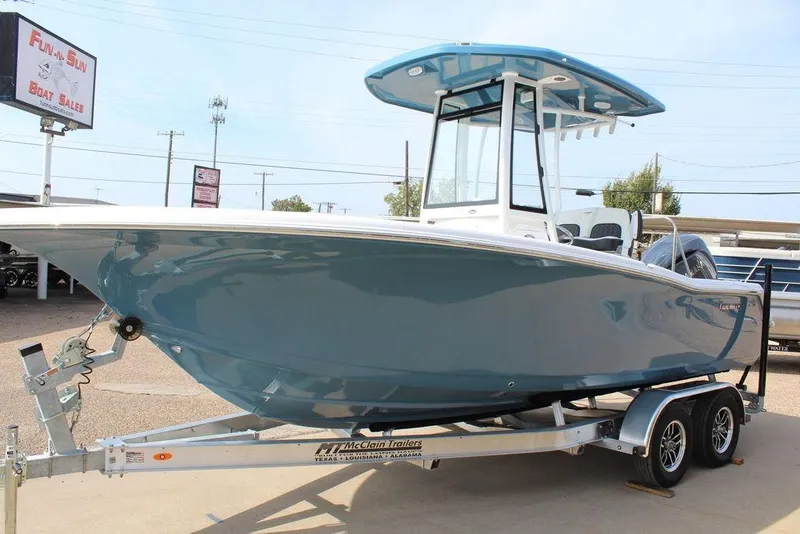 Slide: The Image of 2026 Tidewater 220 CC Adventure boat on trailer at dealership. - 7