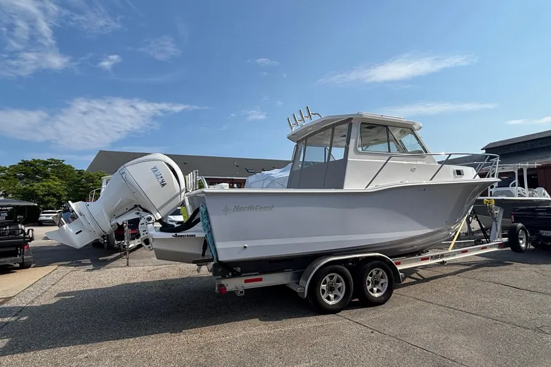 Slide: The Image of 2026 NorthCoast 255 HT boat on trailer, featuring Yamaha outboard motor, under clear blue sky. - 3