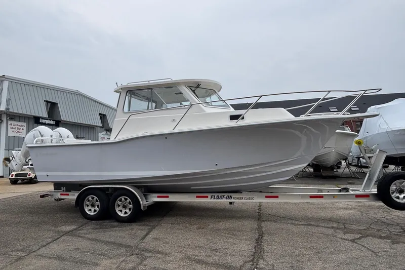 Slide: The Image of 2026 NorthCoast 255 HT boat on trailer, displayed outdoors. - 4